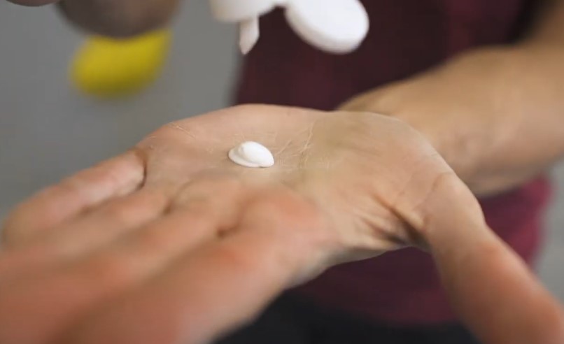 Applying a liquid chalk on hands, before bouldering